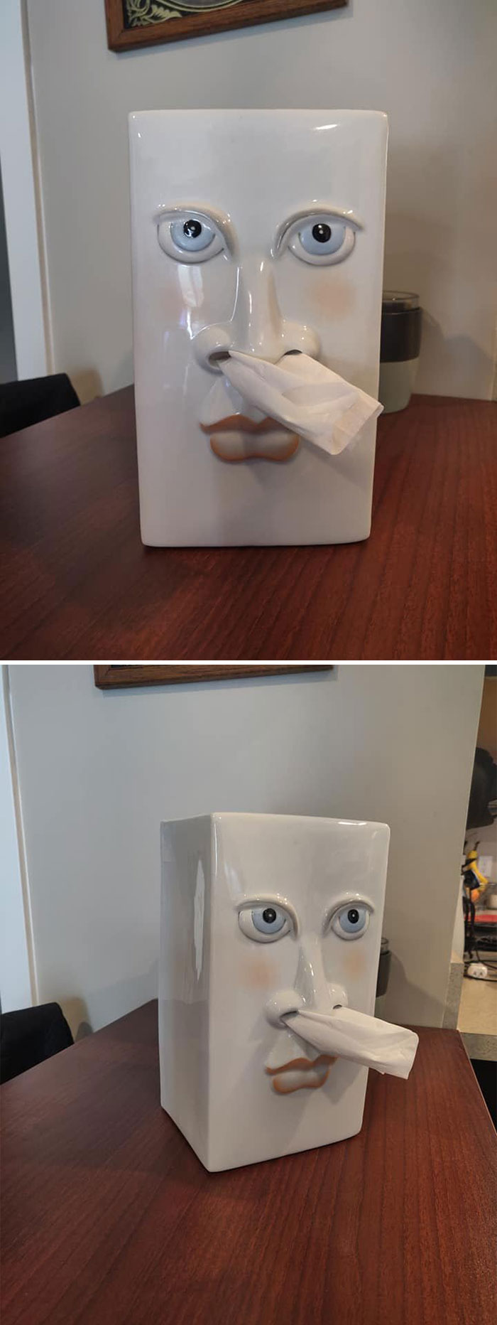 Weird secondhand find: ceramic tissue holder with face design on a wooden table.
