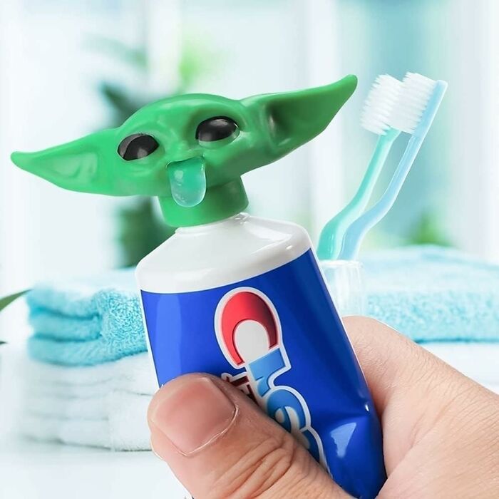 A quirky green alien-shaped toothpaste cap with a toothbrush in the background, a funniest Amazon find.