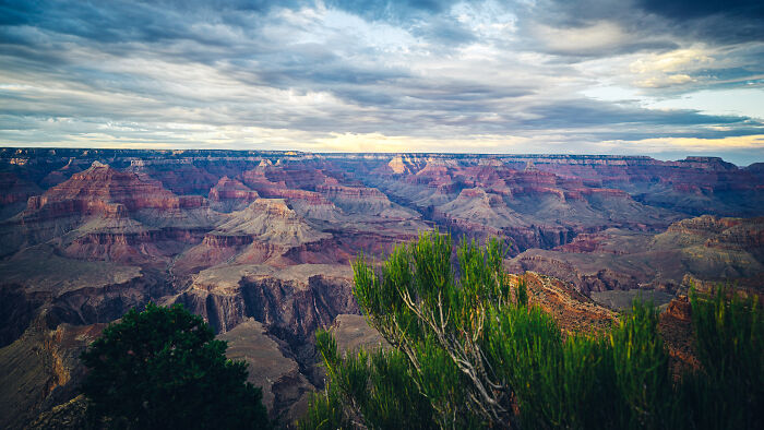 Breathtaking view of the Grand Canyon with vibrant colors and dramatic clouds, showcasing amazing views in the states.