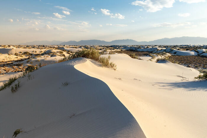 Sand dunes under a clear sky, illustrating amazing views in desert landscapes.