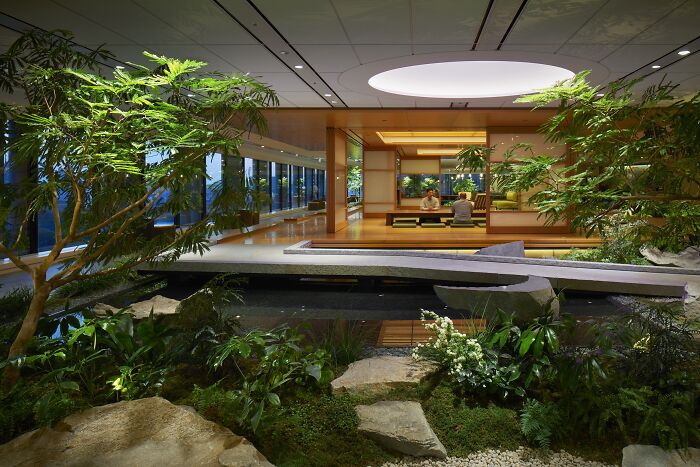 Elegant interior design with lush indoor garden, featuring modern architecture and natural elements, showcasing award-winning excellence.