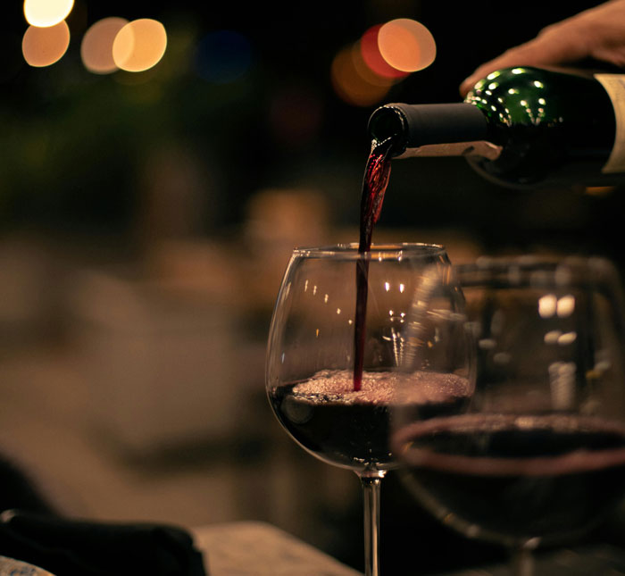 Wine being poured into a glass, symbolizing a sobriety milestone awareness challenge. Wine being poured into a glass, symbolizing a sobriety milestone awareness challenge.