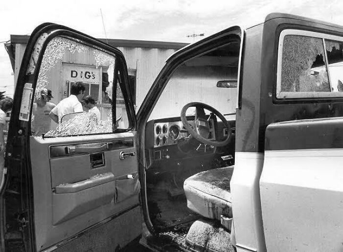 Interior of a vandalized truck with broken windows and dirty seats, illustrating chaotic good morally grey acts.