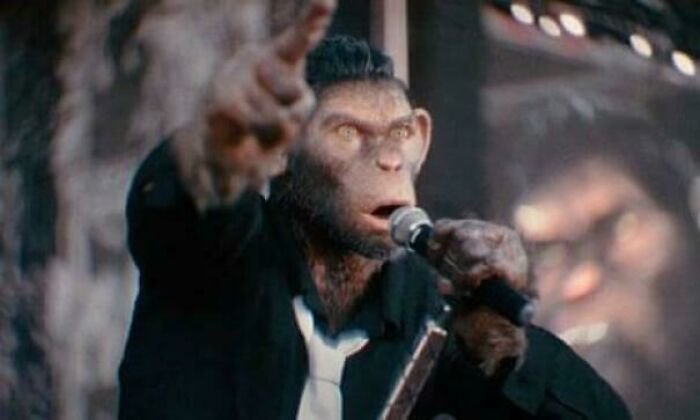 A CGI ape character in a suit pointing while speaking into a microphone highlighting questionable movie details.