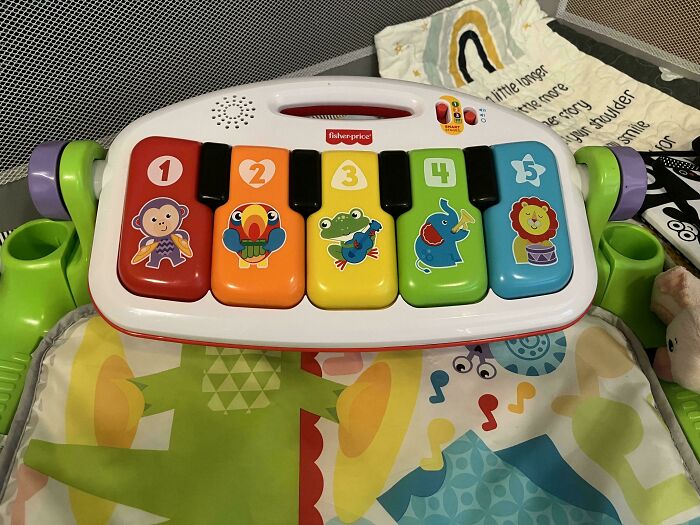 Colorful toy piano with animal designs on keys, used by dads to create rewarding playtime moments.