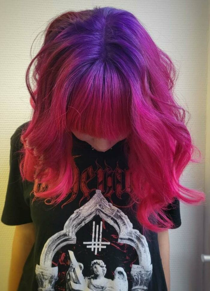 Vibrant hair transition from dark purple to bright pink, showcasing unique hair coloring.