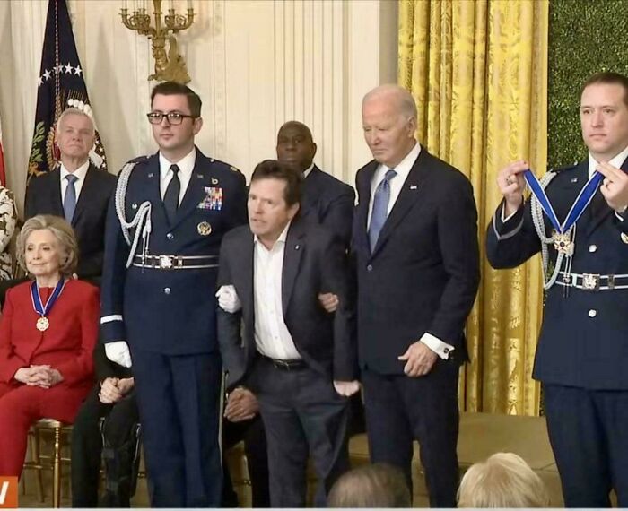A group of individuals in a formal setting with medals, showcasing interesting and fascinating moments.
