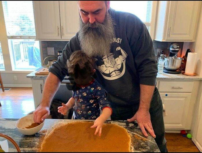 Dad and child baking together in the kitchen, illustrating the joy of being a dad.