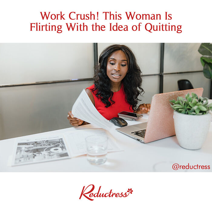 Woman in red dress at desk with laptop and papers, illustrating funny fake article headlines from Reductress online magazine.