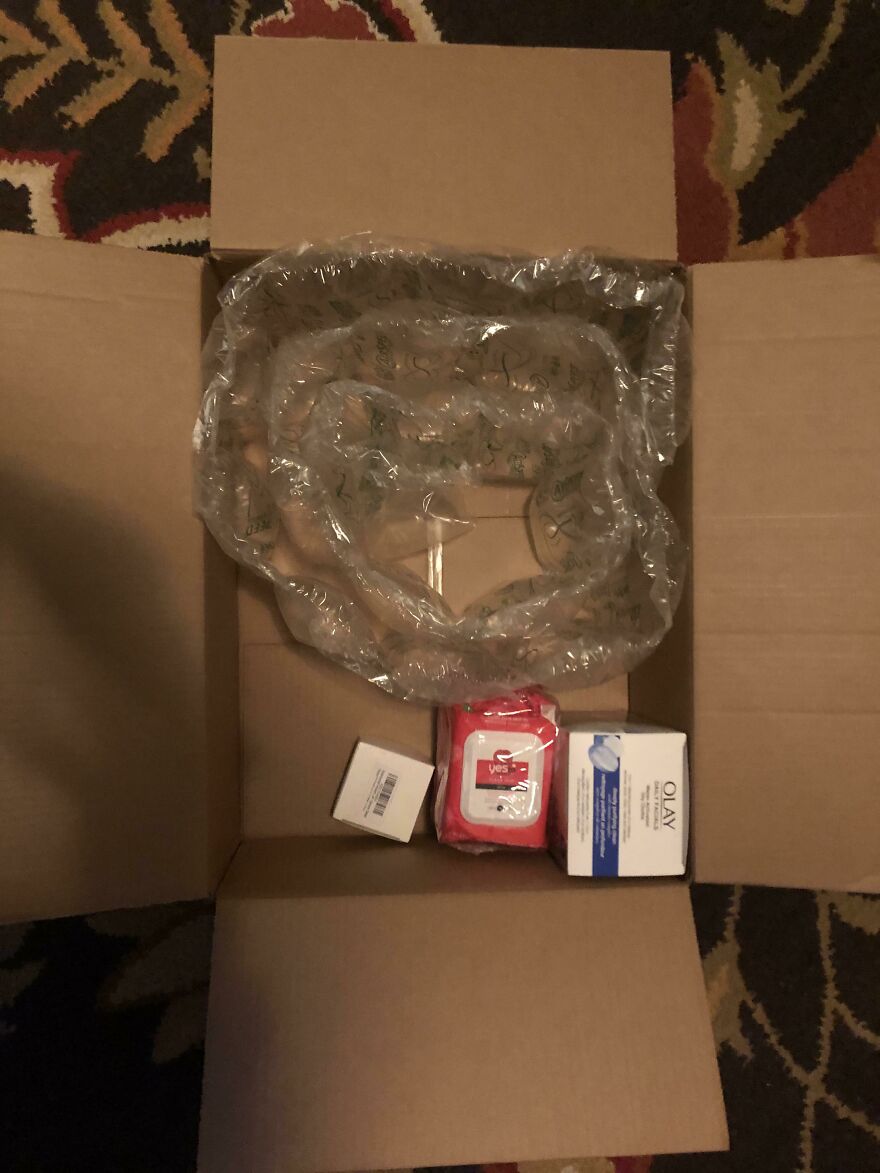 Large box with small items and excessive bubble wrap, illustrating wasteful unnecessary packaging.