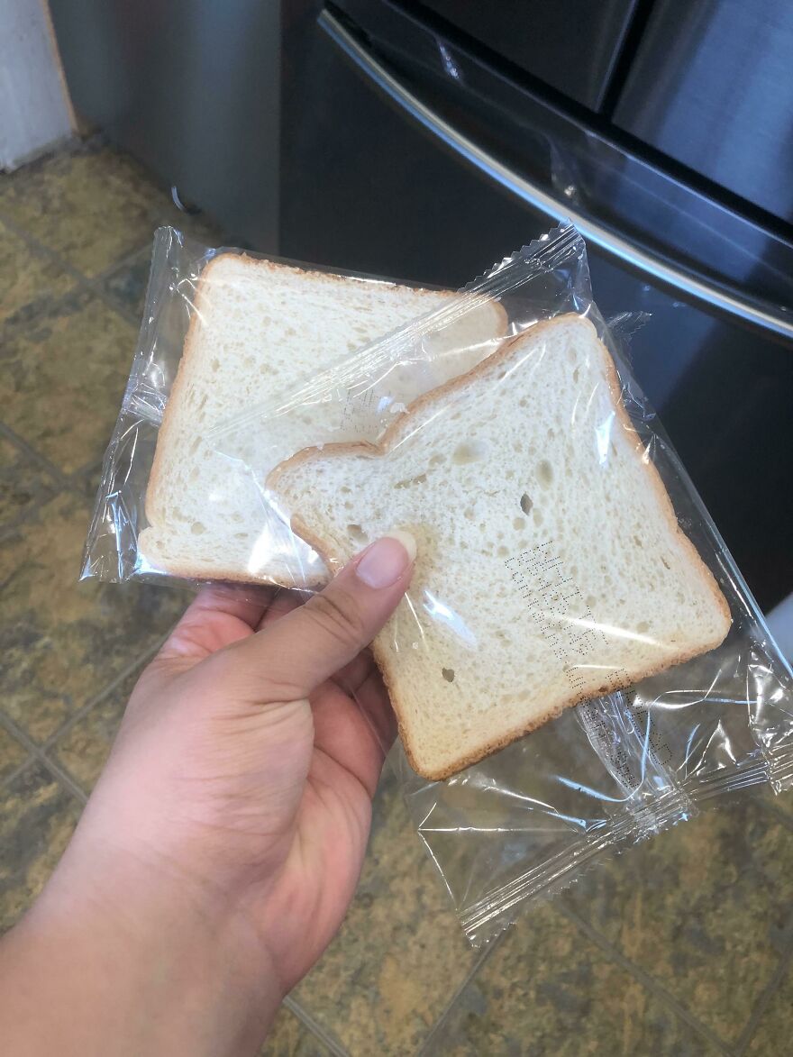 Two slices of bread individually wrapped in plastic, highlighting wasteful unnecessary packaging.