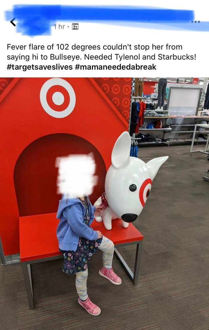 Child sitting beside Bullseye statue at Target, showcasing Ignorant-Parents' shopping experience.