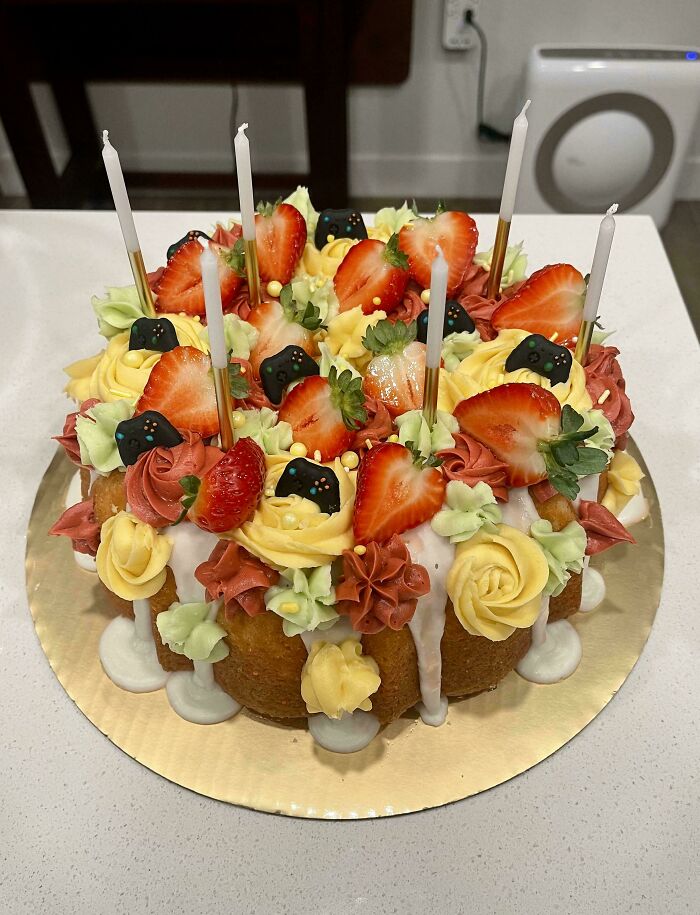 Decorative cake with strawberries, roses, and candles showcasing bakers' culinary concoctions at another level.