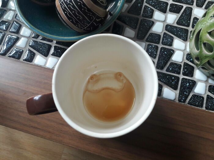 Coffee cup with a smiley face formed by the remaining liquid, illustrating pareidolia.