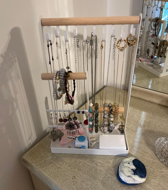 Jewelry organizer neatly storing necklaces, bracelets, and earrings to help cut down on the mess and clutter at home.