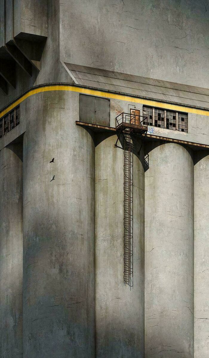 Massive concrete silos with rusted metal stairs and a small platform, illustrating extreme megalophobia scale.