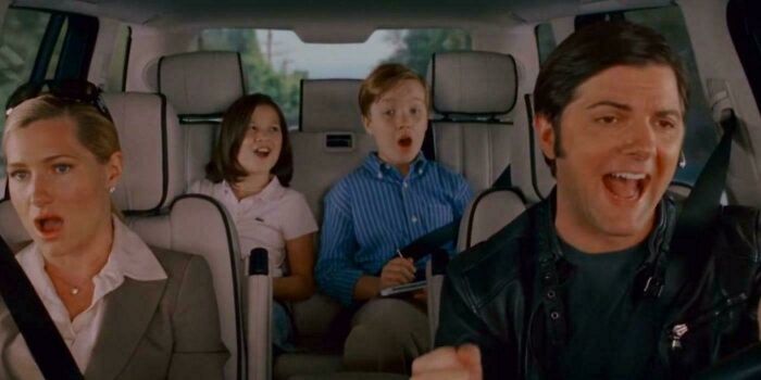 Four people in a car reacting with surprise and joy in a scene highlighting questionable movie details mocked by cinephiles online.