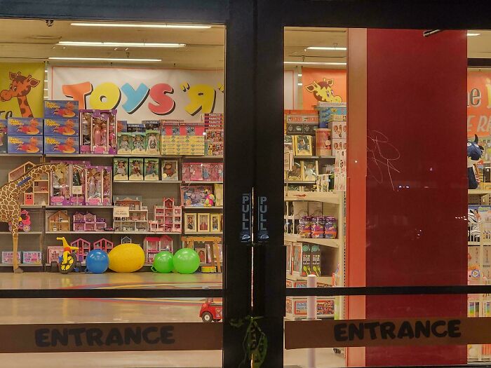 Toys store entrance showcasing 80s nostalgia with colorful displays of retro toys and games inside.