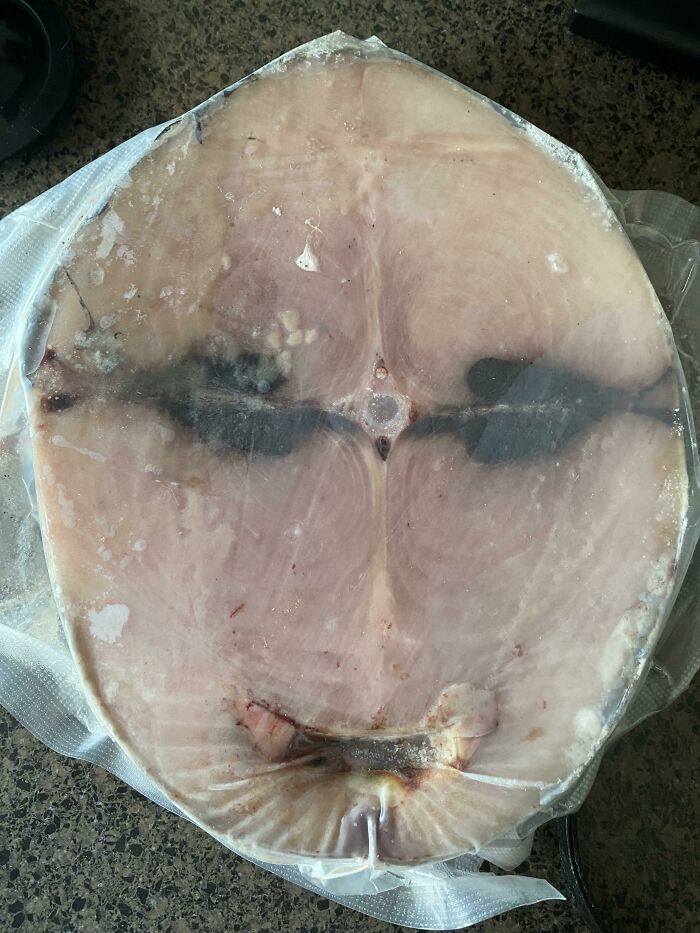 A slice of meat displaying a face-like pattern, a classic example of pareidolia.