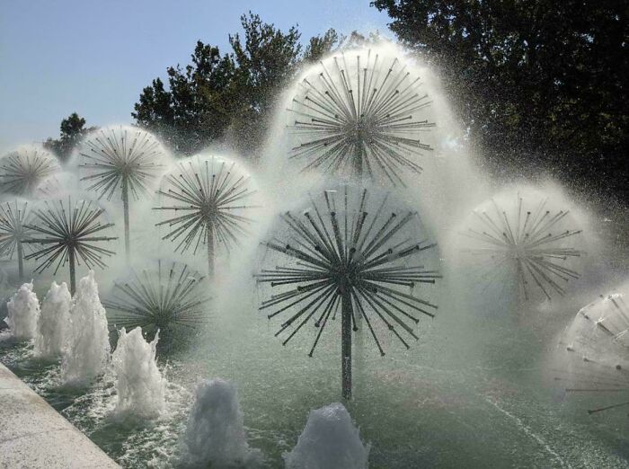 Innovative water fountain design resembling dandelion shapes, showcasing brilliant design ideas that went viral in public spaces.