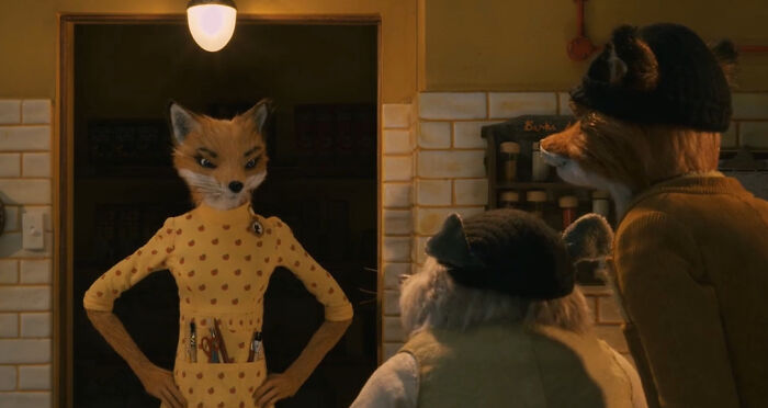 Animated fox character in a yellow dress talking to other animal characters, highlighting questionable movie details in film scenes.
