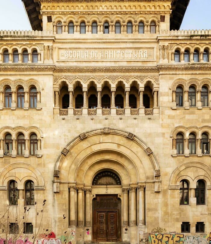 Historic building showcasing impressive architectural feats with ornate arches, columns, and detailed stonework on the facade.