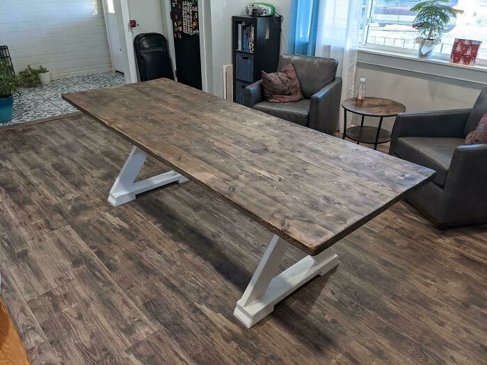 Wooden table in a cozy living room setting, highlighting themes of consumerism.