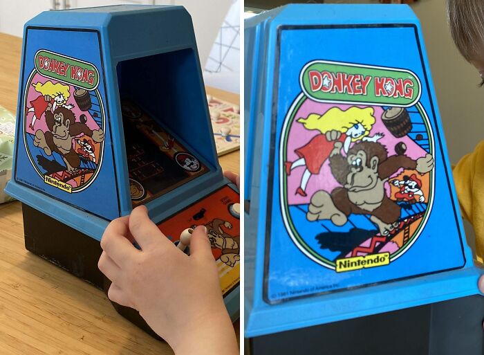 Child playing with an 80s Donkey Kong tabletop arcade game, showcasing vintage Nintendo design.