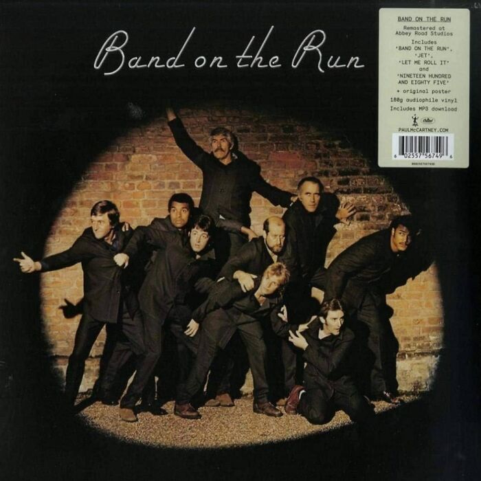 '70s album "Band on the Run" cover art with a group of men posed dramatically against a brick wall.