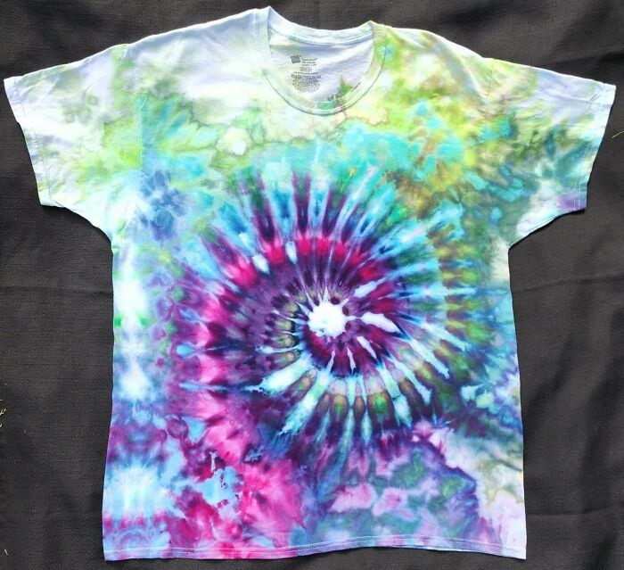 Colorful DIY tie-dye t-shirt with vibrant spiral pattern on a dark background.
