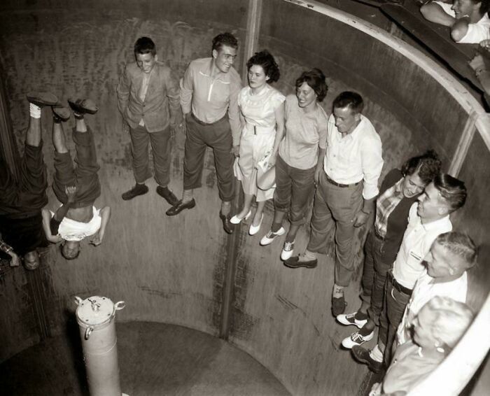 Group of young people riding a wall of death motorcycle stunt in a nostalgic photo evoking feeling of being old.