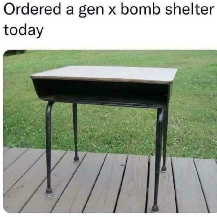 Old school metal school desk outside on a wooden deck, reflecting nostalgic photos that might make you say heck I’m old.