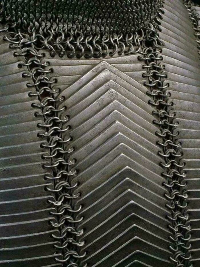 Intricate metal armor showing interlocking chainmail pattern.