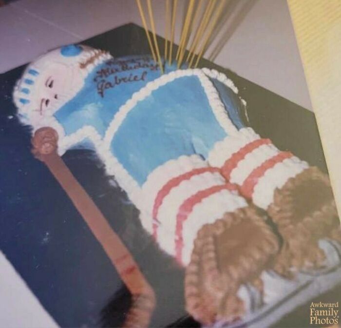 Blue and white vintage birthday cake shaped like a person, capturing an awkward family photo moment with sweet charm.
