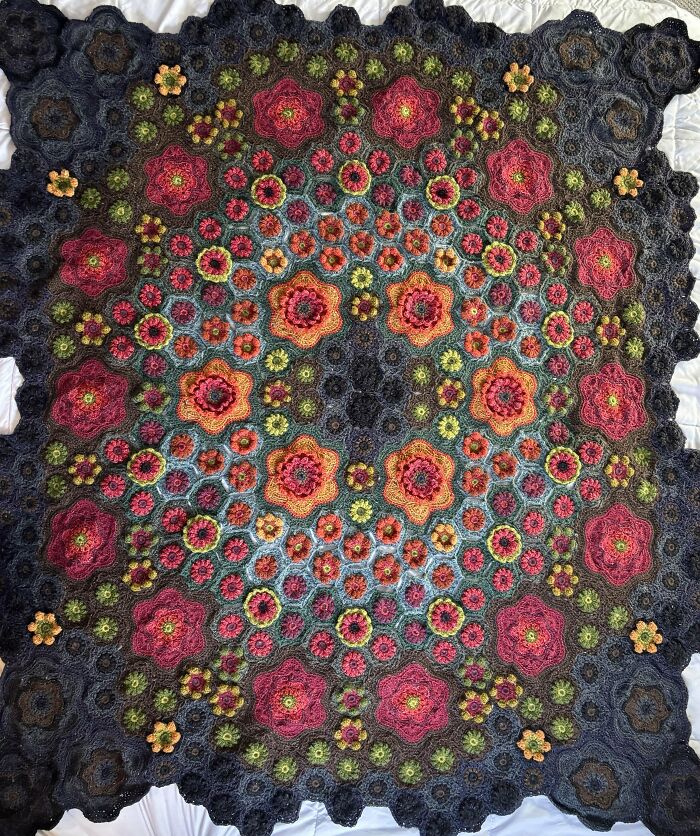 Colorful floral crochet blanket showcasing intricate patterns and vibrant yarn, perfect for crochet enthusiasts' proud projects.