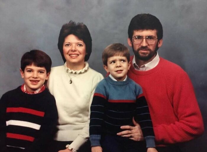 Family portrait with awkward poses and mismatched sweaters, capturing a sweet and nostalgic moment.
