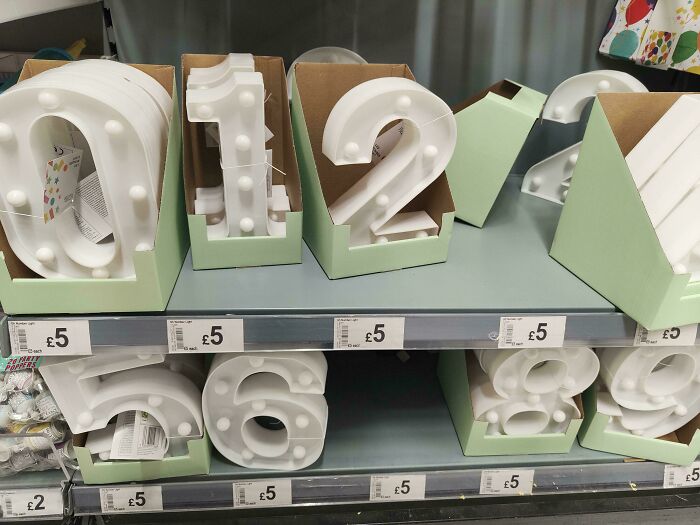 Numbers 0-9 on sale for £5 each, highlighting irony in consumerism.