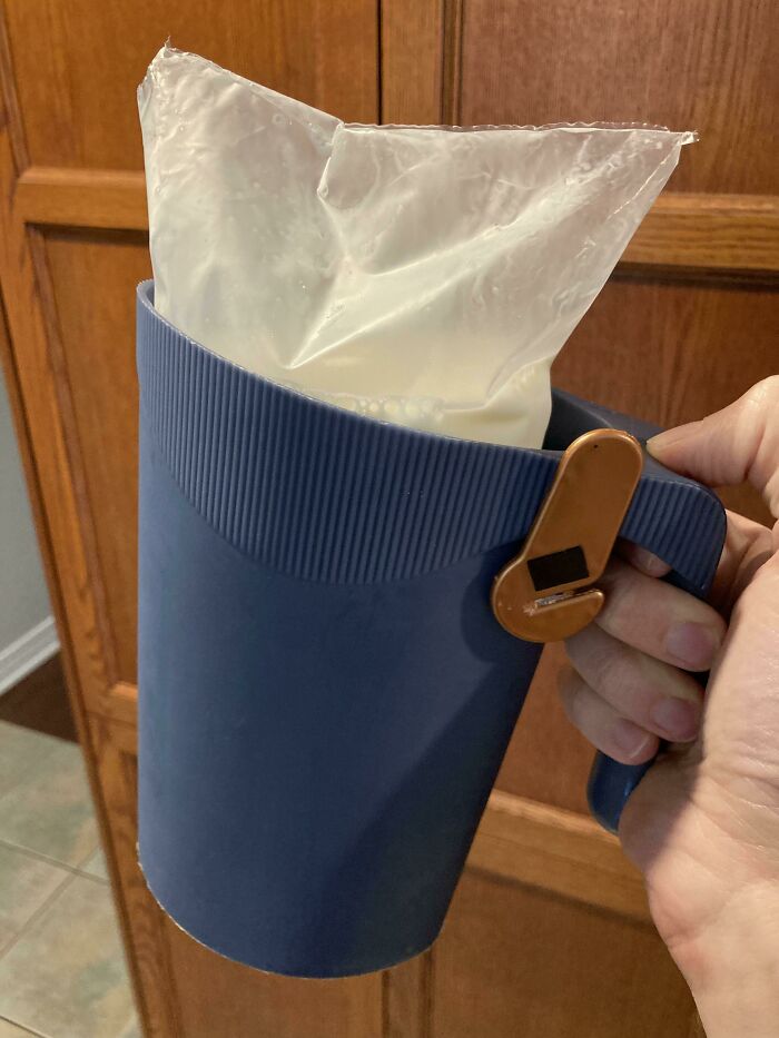 A blue jug holding a bag of milk with a clip, showcasing a cool product with a surprise feature.