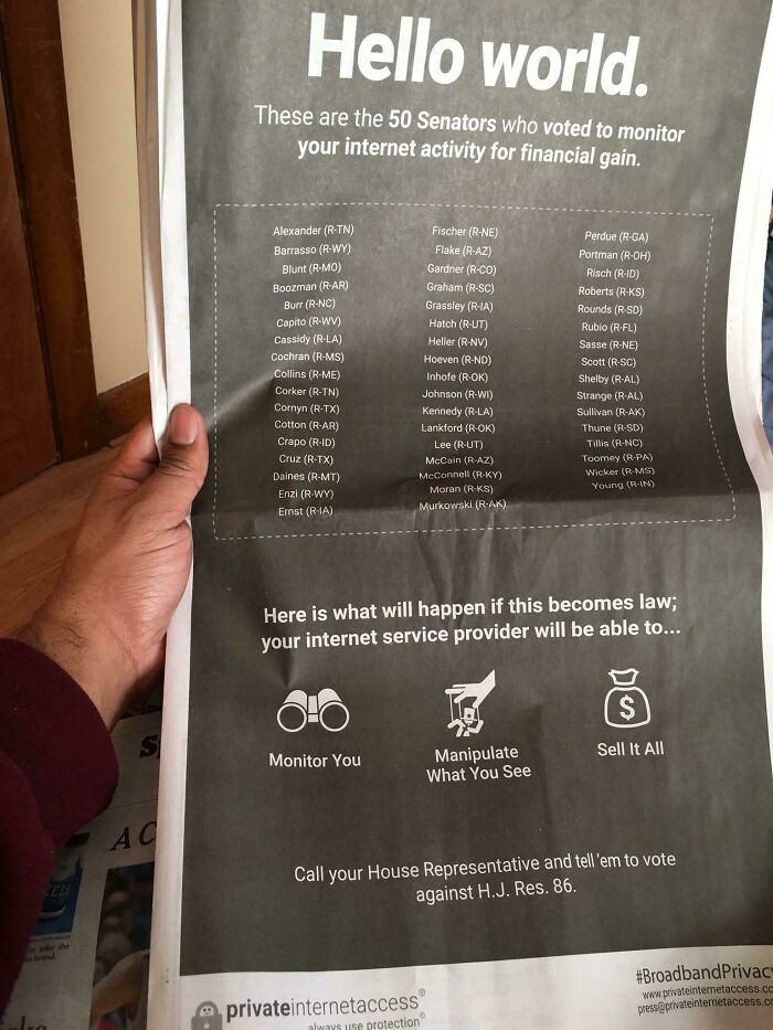 Person holding a newspaper listing 50 senators who voted for monitoring internet activity for profit.