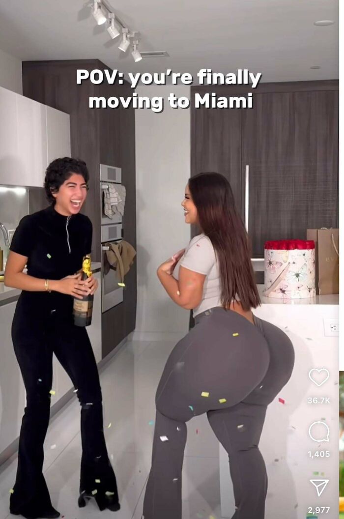 Two women in a modern kitchen, one holding champagne, with exaggerated airbrushed features, celebrating with confetti.