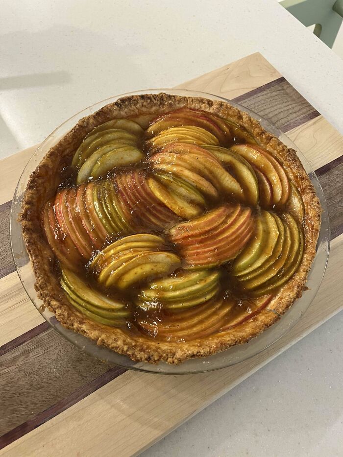 Delicious pie with artfully arranged apple slices, showcasing bakers' culinary concoctions at a whole other level.