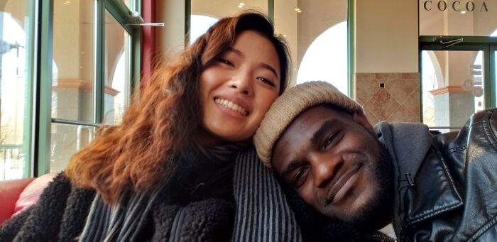 A happy couple smiling in a cozy setting, showcasing long-distance love.