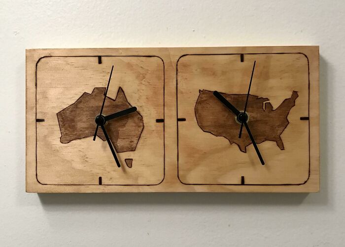 Wooden clock showing maps of Australia and USA, symbolizing long-distance love.