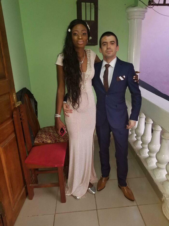 Couple posing together in formal attire, showcasing love and connection despite long-distance challenges.