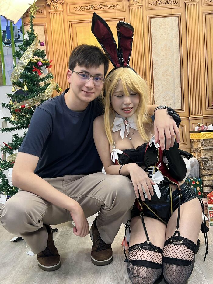 A smiling couple in festive attire pose together, showcasing long-distance love.