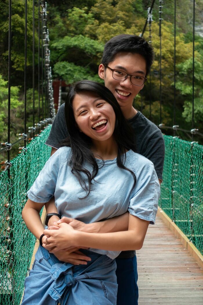 A happy couple embracing on a bridge, showcasing long-distance love.