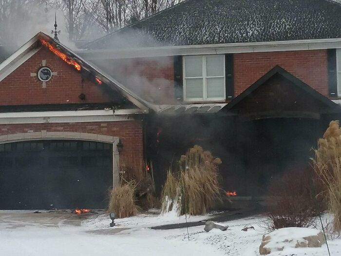 Burning house covered in snow, illustrating a nature disaster with resilience challenges.