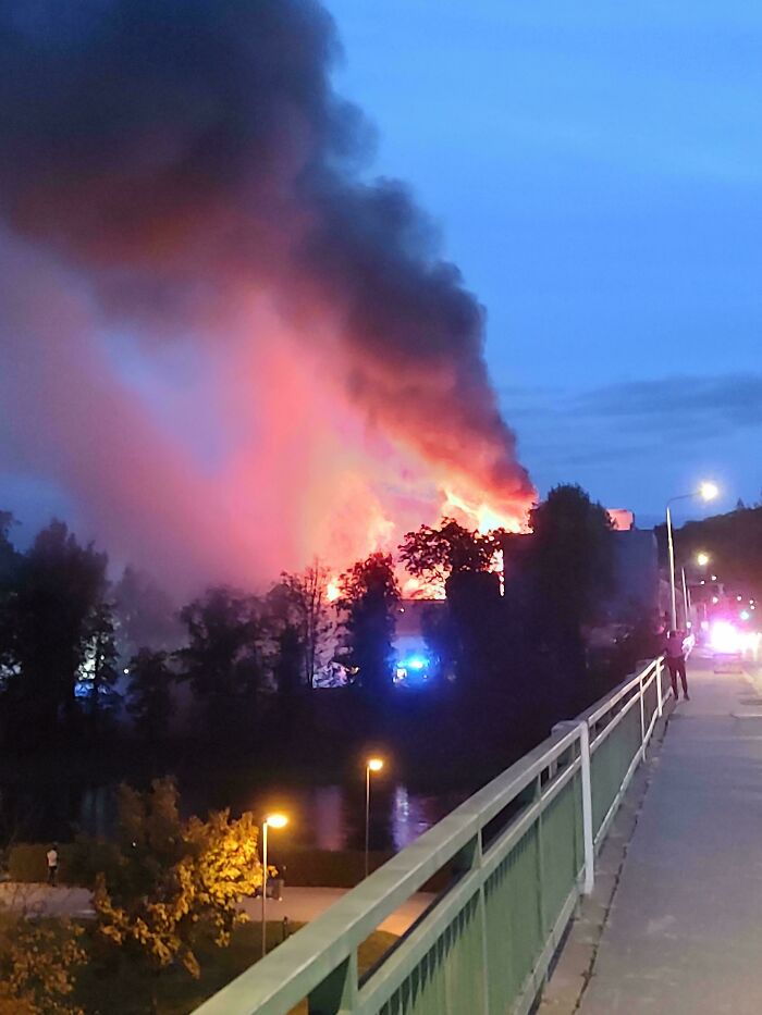 Massive fire with smoke rising, highlighting the importance of nature disaster resilience in urban areas.