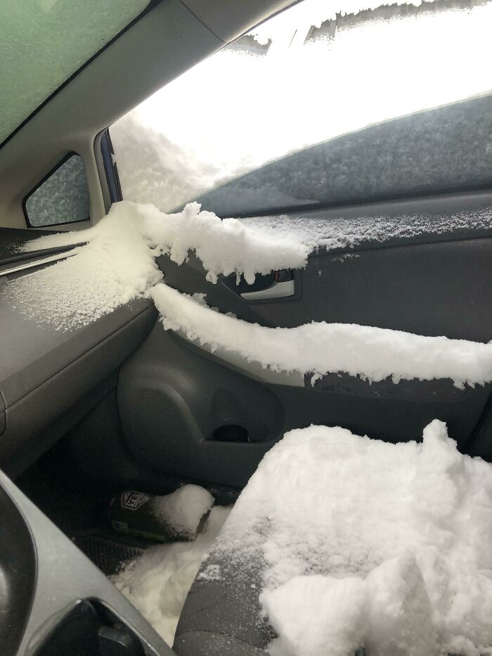 Snow inside a car, illustrating nature disaster resilience challenges with heavy winter conditions.