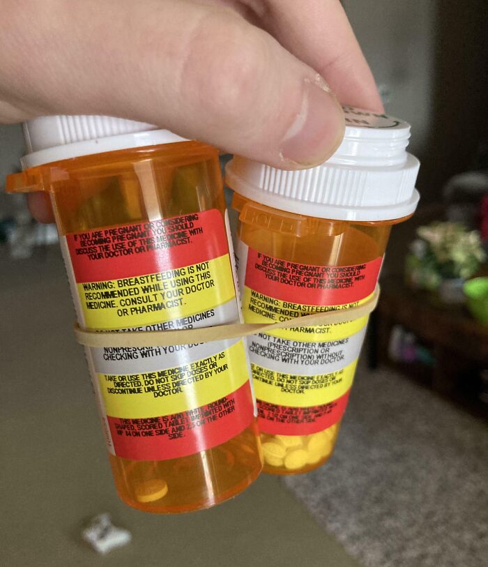 Two prescription pill bottles with warning labels from local pharmacies.